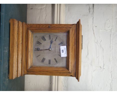 An oak cased mantel clock, retailed by Edward & Sons of London and Glasgow, with silvered dial and single train W&H movement,