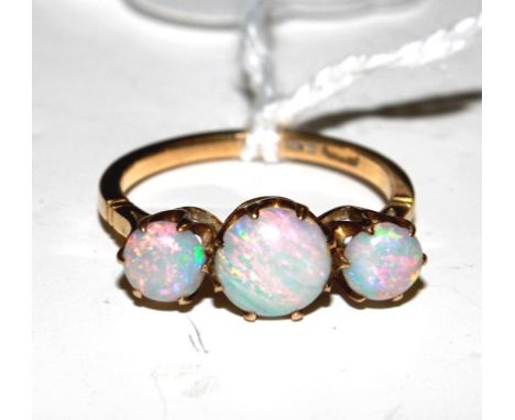 A three stone opal ring, set in rose gold