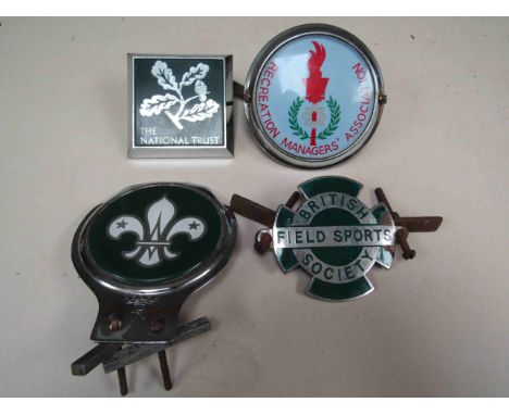 Four car badges 'Scouts', 'The National Trust', 'Recreation Managers Association' and 'British Field Sports Society' which ha