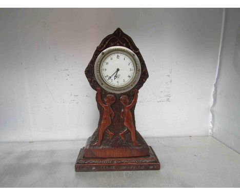 A vintage Smiths car clock mounted in a carved surround 
