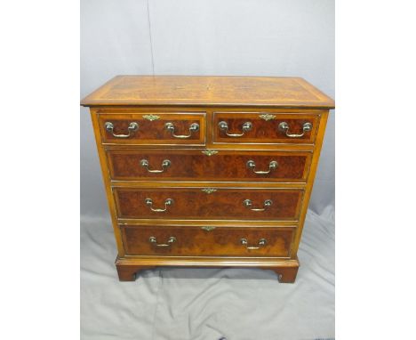 TWO REPRODUCTION BURR WALNUT &amp; MAHOGANY EFFECT CHESTS OF DRAWERS both having inlaid star detail to the tops, 92.5cms H, 9
