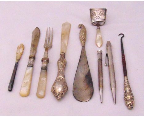 Two silver propelling pencils, a silver and mother of pearl caddy spoon, a knife, a fork, a letter opener and tweezers, a sho