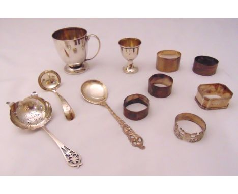 A quantity of hallmarked silver and white metal to include a cup, an egg cup, napkin rings, a cream ladle and a spoon, approx