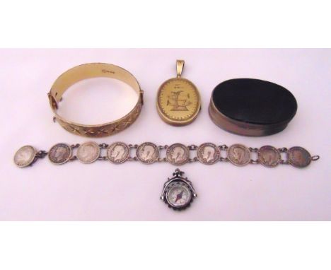 A quantity of silver jewellery to include a sixpence bracelet, a gilt locket, a band bracelet, a compass pendant and a patch 