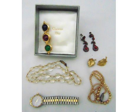 A quantity of costume jewellery to include earrings, necklaces, a wristwatch and a Christian Dior brooch