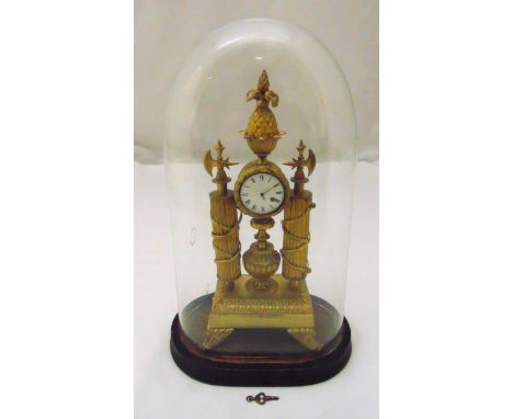 A French 19th century gilt metal mantle clock of drum form, white enamel dial flanked by two fluted columns and surmounted by