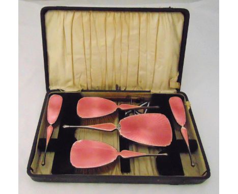 A hallmarked silver and enamel cased dressing table set to include a hand mirror, hair brushes and clothes brushes, A/F
