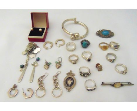 A quantity of silver and costume jewellery to include rings, earrings, a bangle and brooches