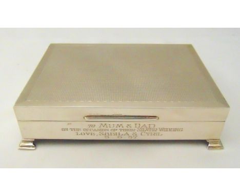 A hallmarked silver presentation cigarette box, rectangular engine turned, cedar wood lined on four bracket feet, Birmingham 