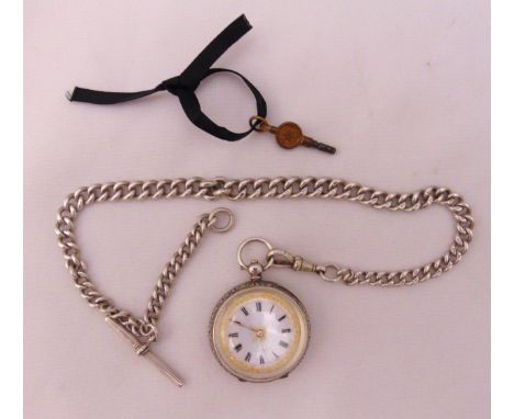 A Victorian silver pocket watch with white enamel dial and Roman numerals, a hallmarked silver Albert chain with fob and a ke