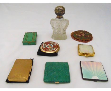 Seven compacts of various form and shape, a cut glass perfume bottle with silver cover and a hallmarked silver and enamel com