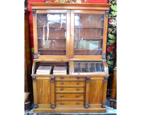 An antique mahogany part glazed collectors cabinet, with a pair of glazed in doors and side panels over two glazed in cylinde