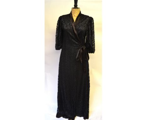 An unusual 1930s black silk wrap-style evening dress with overall cut-out work and silk satin trim to neckline and crepe silk