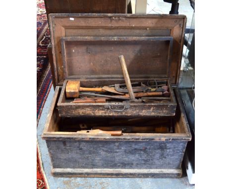 A vintage stained pine carpenter's tool trunk with assorted contents including block and moulding planes, chisels, brace and 