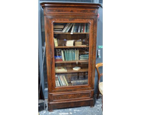 A 19th century Continental mahogany library bookcase, the moulded cornice over a single glazed door enclosing adjustable shel