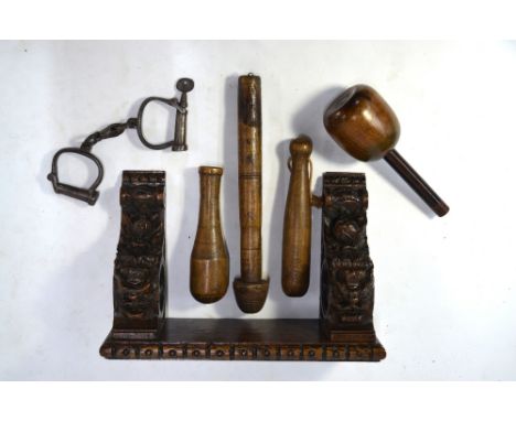 A carved oak wall bracket worked with grotesque masks and Gothic quatrefoils to/w a turned wood sculptors mallet, a lead-weig