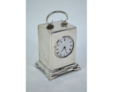 An Edwardian silver boudoir clock with platform escapement and enamel dial, the case with top swing handle and bracket feet, 
