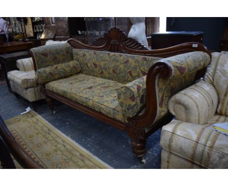 A Regency mahogany framed sofa with scroll ends, raised on turned legs to ceramic castors, 200 cm long