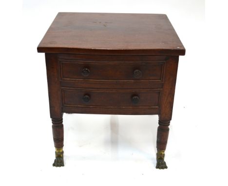 A 19th Century mahogany commode with hinged cover enclosing the original china pot and wooden cover, over a two dummy drawer 