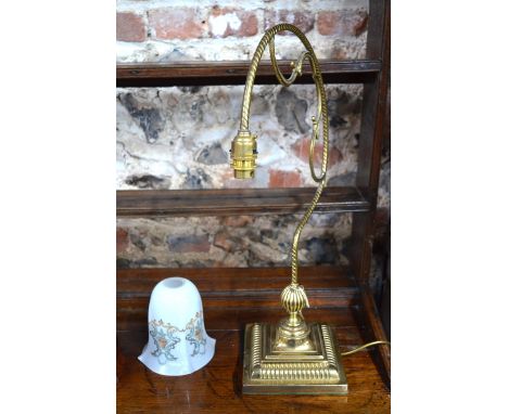 A brass desk-lamp with glass shade, scrolling branch and weighted square foot, 55 cm high