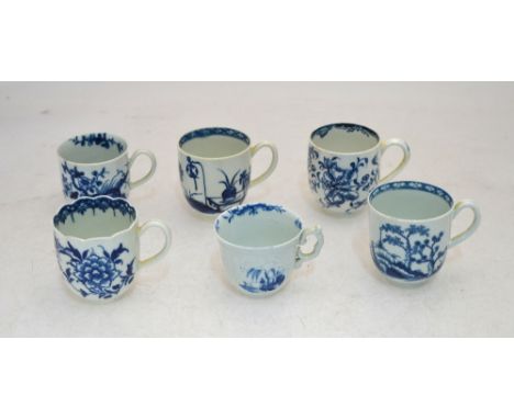 A collection of six 18th century blue and white Worcester coffee cups including one with a scalloped rim and another strap mo