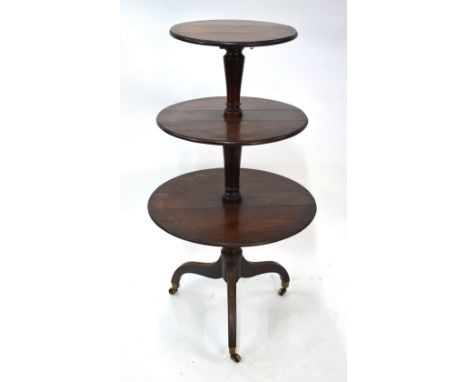 A Victorian mahogany three graduated drop leaf tier dumb waiter, on tripod base to brass castors, 62 cm dia x 102 cm high