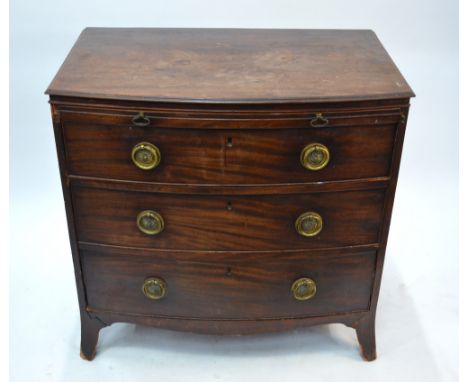 A Victorian mahogany bowfront chest of three long graduated drawers beneath a full width brush slide, raised on splayed brack