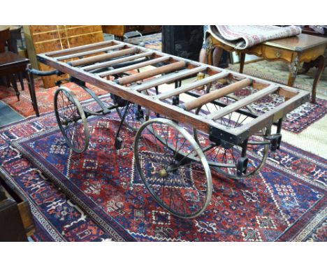 An antique hand-drawn funeral byre, the wooden frame on a leaf sprung twin axle carriage with turn table to one end and foldi