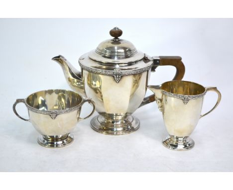 A three-piece silver tea service with floral-cast rim and moulded foot, composite handle and finial, Fenton, Russell &amp; Co