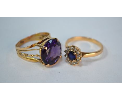 An oval sapphire and diamond cluster ring, yellow metal set stamped 18k to/w a synthetic corundum Alexandrite-type single sto