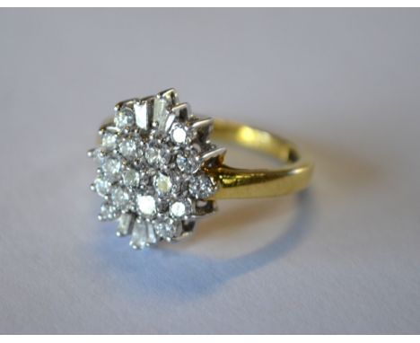 A diamond set marquise shaped cluster ring, having brilliant and tapering cut diamonds, shank stamped Iliana, 18ct yellow and