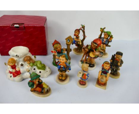 A group of Hummel and similar figures / groups, largest approximately 14.5 cm (h) and a boxed Goebel Oil Lamp With 2 Angels. 