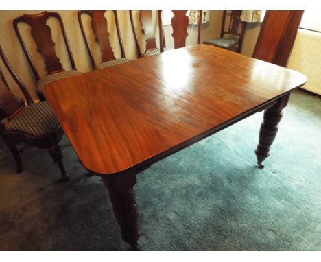 A 19th century mahogany dining table with three removable panels, the turned supports terminating in castors, 76 cm (h) x 99 