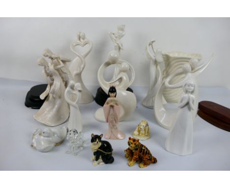 A group of white glaze ceramic figures and stands, a Nao duck group, largest approximately 28 cm (h) and animal form trinket 