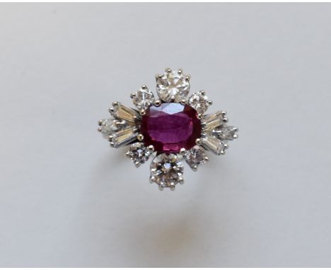 A oval ruby and diamond ring, with baguette diamond shoulders, stamped 18ct, diamond totalling 2.5ct approximately. 