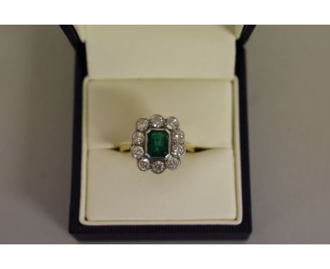 An emerald and diamond gold cluster ring,&nbsp;hallmarked .750/18ct, 4.5g all in. 