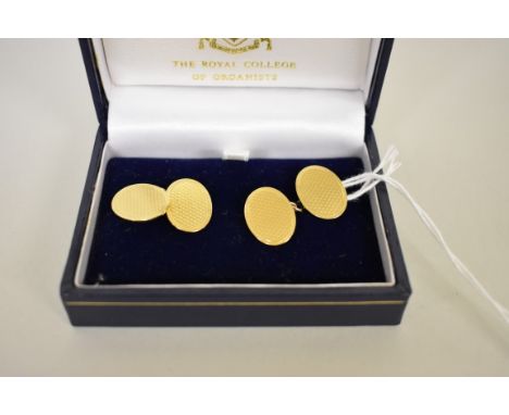 A pair of gold engine turned oval cufflinks,&nbsp;stamped 18ct, 11.2g. 