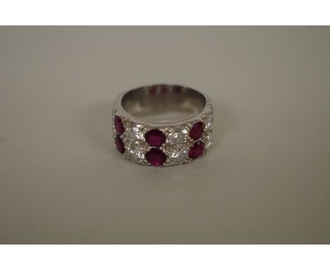 A ruby and diamond double row half eternity ring, the&nbsp;rubies totalling 1ct and diamonds 2ct approximately, stamped .750.