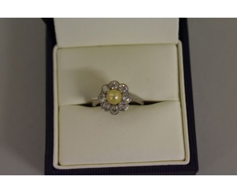 A diamond and pearl floral cluster ring, stamped plat. 