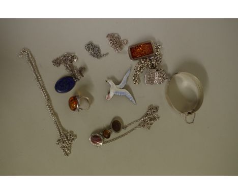 A silver hinged bangle, by G J Ltd, London 1962 having floral chased decoration and set five coral beads; together with a sil