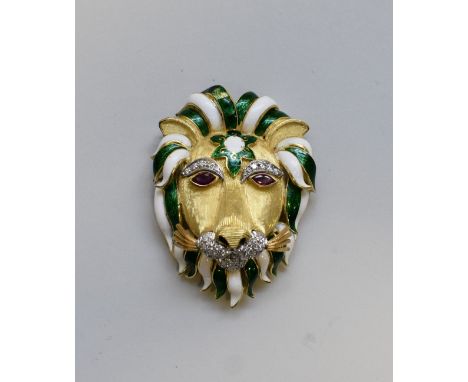 A yellow metal and enamel lion's head brooch,&nbsp;the mane in green and white enamel, having ruby eyes, diamond eyebrows and