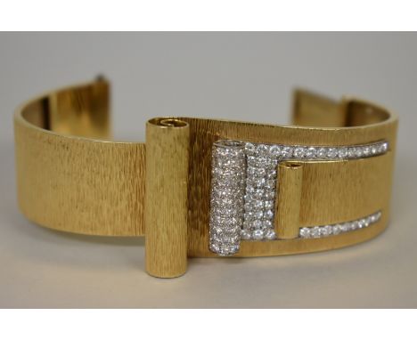 A stylish diamond set and textured yellow metal hinged&nbsp;bangle,&nbsp;unmarked&nbsp;75g all in. 