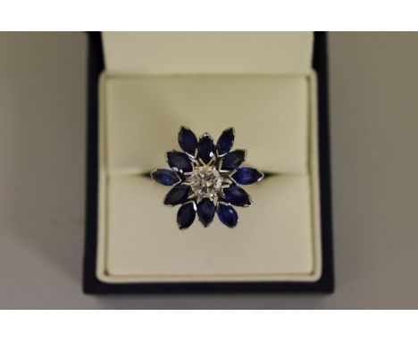 A marquis cut sapphire and diamond daisy cocktail ring, the central diamond approximately 0.75ct,&nbsp;unmarked. 