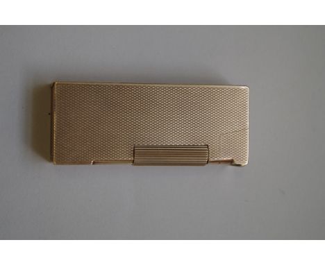 A vintage ADB engine turned 9ct gold lighter. 