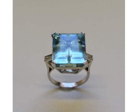 A large rectangular aquamarine cocktail ring, having baguette diamond shoulders,&nbsp;unmarked. 