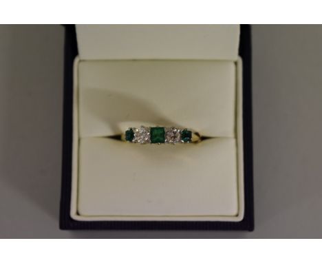 A emerald and diamond&nbsp;five stone&nbsp;gold ring, hallmarked 18ct. 