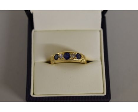 An 18ct gold sapphire and diamond gypsy ring. 