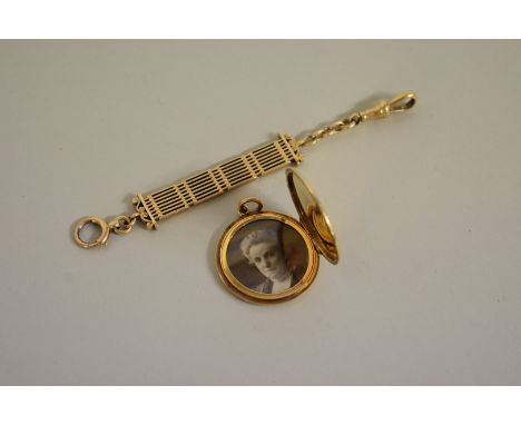 A gold engine turned locket, stamped 15ct,&nbsp;12.3 all in; together with a yellow metal suspension chain, marks rubbed, 14.