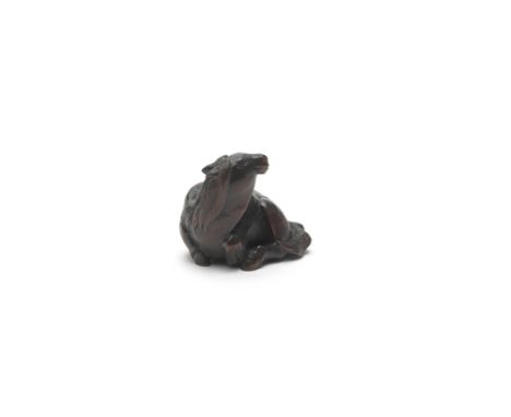 A WOOD NETSUKE OF A RECUMBENT HORSEEdo period (1615-1868) or Meiji era (1868-1912), mid/late 19th centuryThe horse raising it