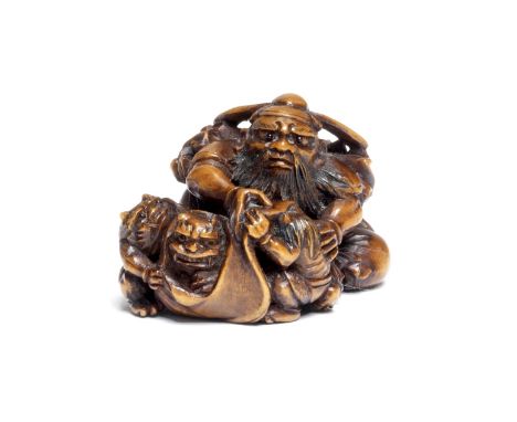 A BOXWOOD NETSUKE OF SHOKI WITH ONI (DEMONS)Attributed to Ohara Mitsuhiro (1810-1875), Osaka, Edo period (1615-1868), 19th ce